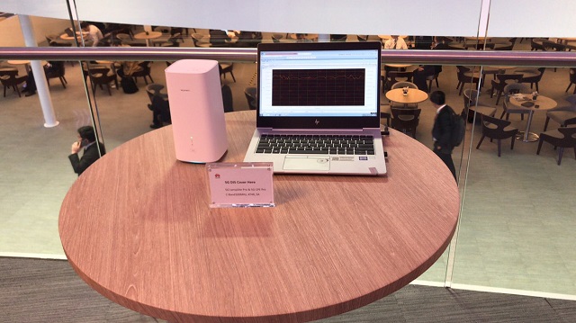 A 5G CPE Pro terminal and a laptop on a table at MWC Barcelona 2019